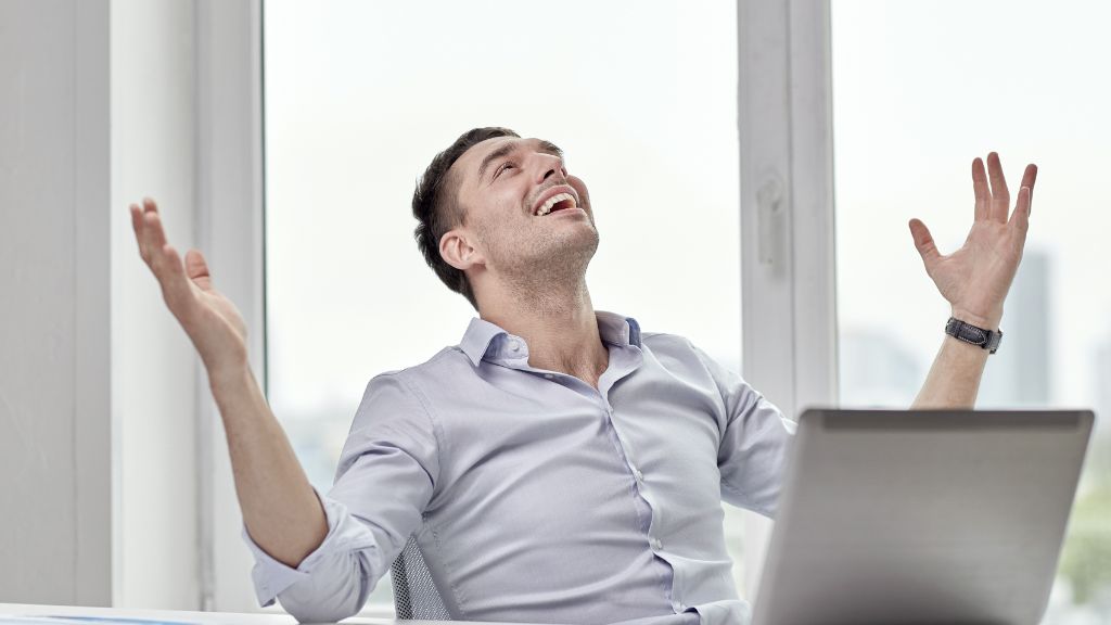 A man throws his hands in the air in celebration after receiving approval for his Minnesota Cannabis Microbusiness License, representing success made possible with guidance from a trusted Minnesota cannabis consultant.