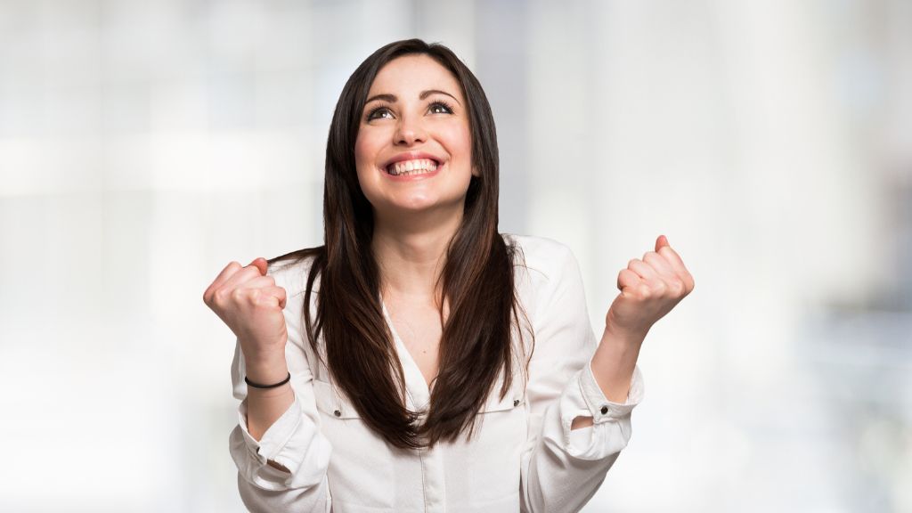 A woman celebrates the approval of her Colorado marijuana license, marking a key step to open a Colorado dispensary or lounge.