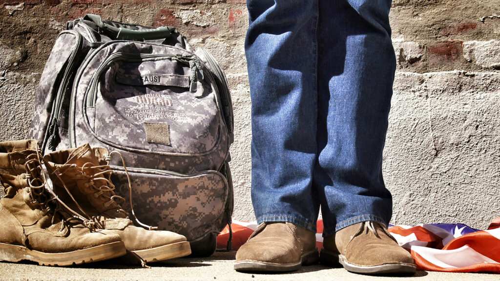 Military veteran in civilian clothes with boots and backpack, symbolizing social equity in Minnesota cannabis industry.