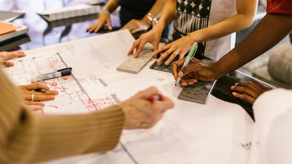Cannabis Business Startup Commissioning team reviewing building blueprints to ensure Cannabis Operational Readiness with support from a Cannabis Consultant