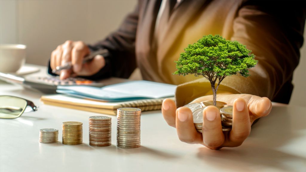 Compliance officer reviewing reports at desk with growing stacks of coins and a green tree symbolizing cannabis Risk Management, Cannabis Compliance, and Cannabis Consultant support