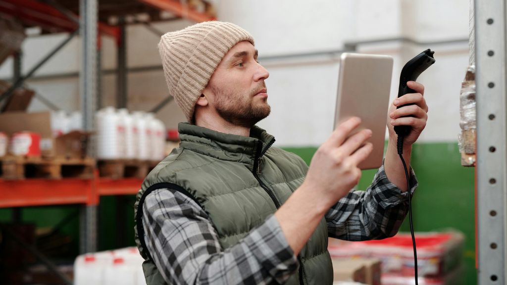 Cannabis professional using Seed-to-Sale Tracking Systems to manage inventory and ensure Cannabis Compliance with advanced Cannabis Technology