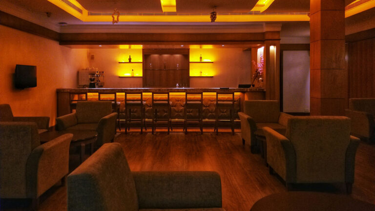 Modern interior of an Alaska cannabis lounge with ambient lighting and comfortable seating.