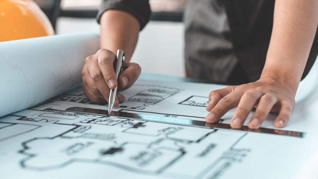 Designer reviewing cannabis lounge design blueprint with input from a Cannabis Consultant