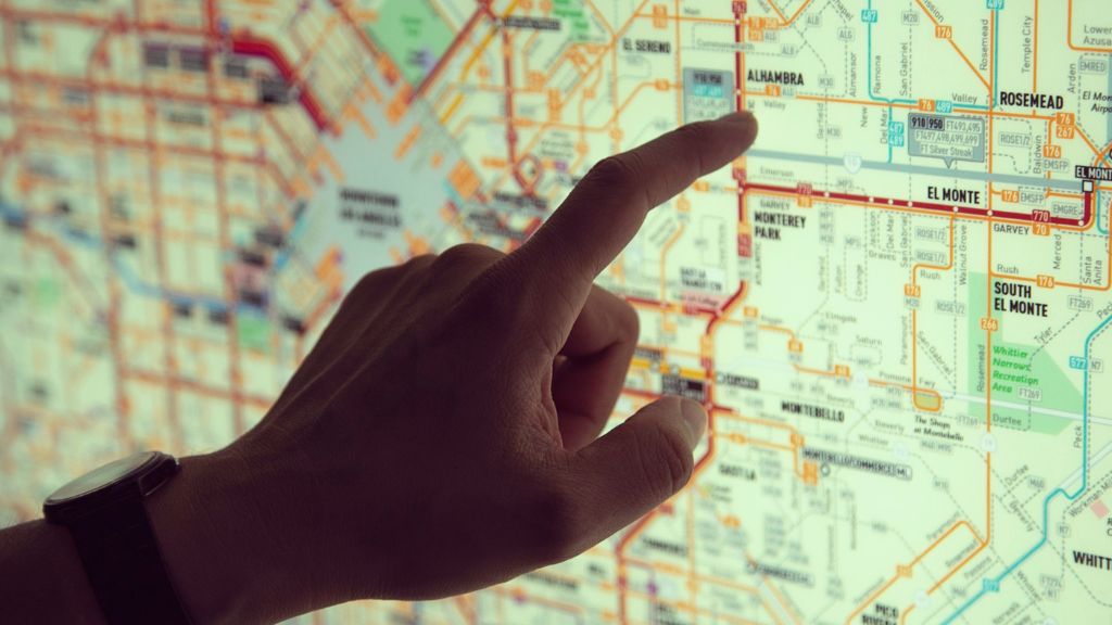 Man reviewing cannabis lounge location options on a digital map with guidance from a Cannabis Consultant