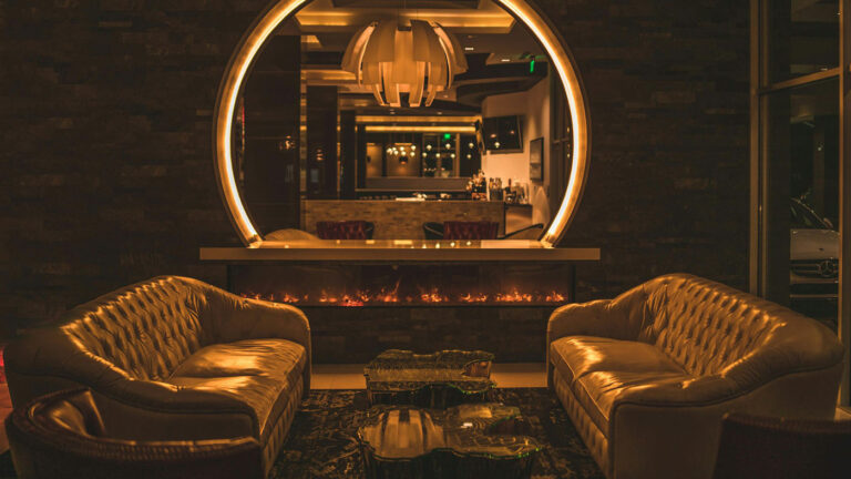 Interior of a modern Illinois cannabis lounge with dim lighting and lounge seating