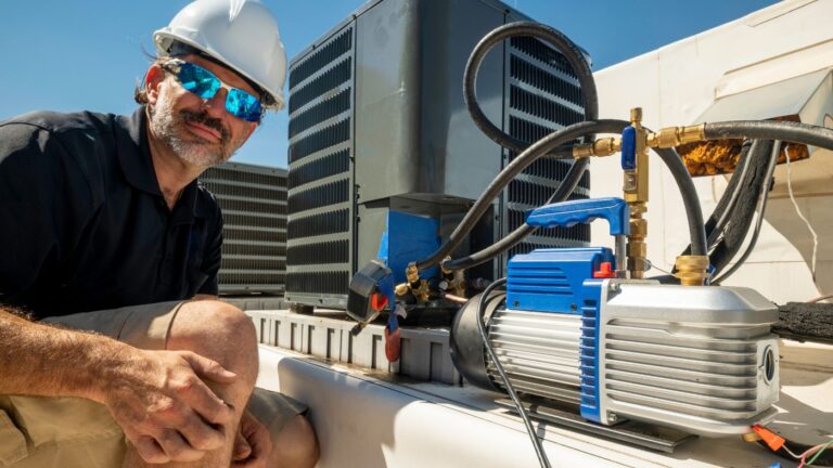 HVAC professional inspecting rooftop HVAC unit at an indoor cannabis cultivation facility for compliance and energy efficiency.