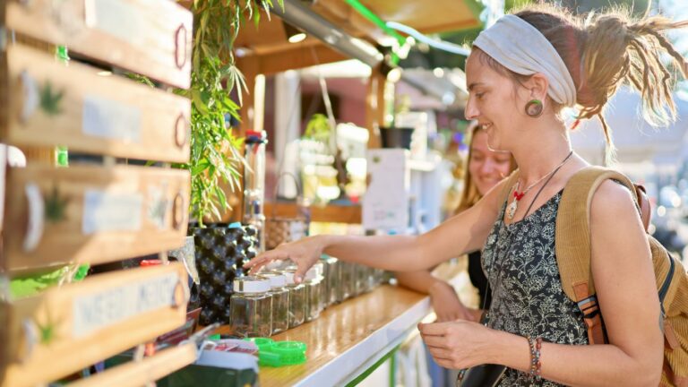 A woman browsing cannabis products at a Rhode Island dispensary, symbolizing opportunities created by the Rhode Island Marijuana Dispensary License process.