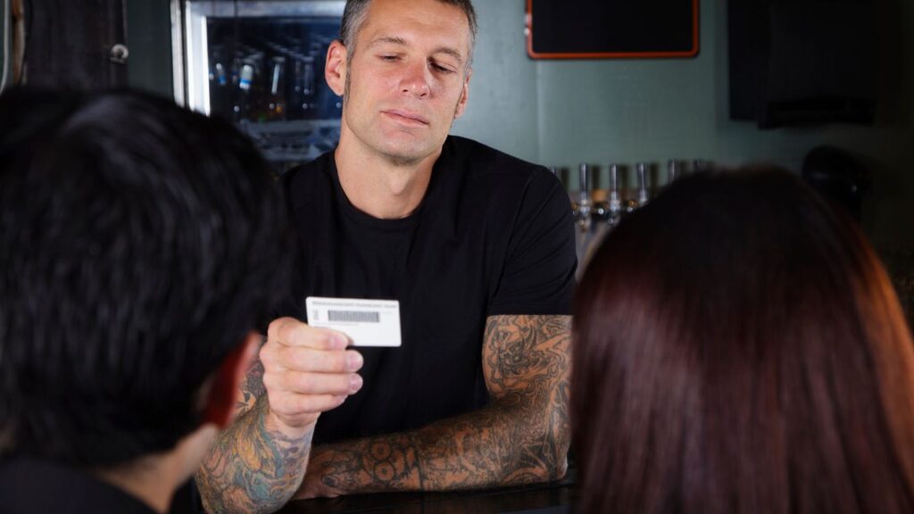Cannabis dispensary budtender performing an ID check as part of a Dispensary Secret Shopper compliance audit focused on Age Verification SOP.