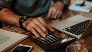 A specialized accountant calculating COGS for complex Cannabis 280E Compliance IRS paperwork, utilizing Cannabis Cost Segregation to optimize deductions.