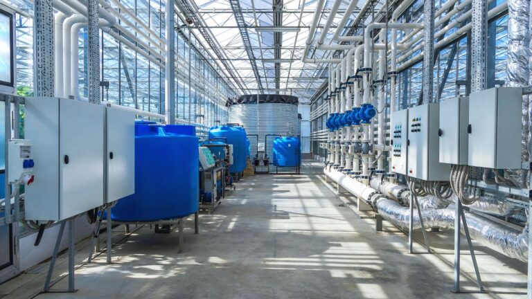 Large-scale commercial water and nutrient control center with massive holding tanks for cannabis cultivation.