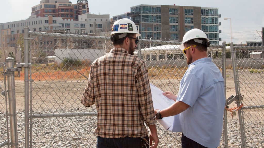 Leif Olsen and Michael Williamson of Catalyst BC reviewing blueprints at a cannabis facility construction site.